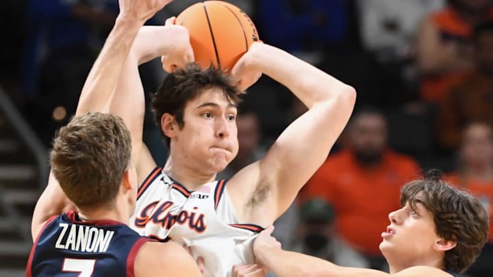 Penn Quakers guard Michael Zanoni (7) and Penn Quakers guard AJ Levine (0) defend Illinois Fighting Illini forward David Mirkovic (0) in the NCAA Men’s Basketball Tournament first-round game.
