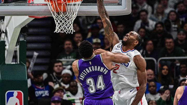 Feb 2, 2023; Milwaukee, Wisconsin, USA; Los Angeles Clippers guard Kawhi Leonard (2) attempts a dunk against Milwaukee Bucks forward Giannis Antetokounmpo (34) in the third quarter at Fiserv Forum. Mandatory Credit: Benny Sieu-Imagn Images