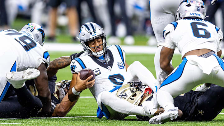 Sep 8, 2024; New Orleans, Louisiana, USA;  Carolina Panthers quarterback Bryce Young (9) is tackled as he scrambles out the pocket by New Orleans Saints cornerback Alontae Taylor (1) during the second half at Caesars Superdome. Mandatory Credit: Stephen Lew-Imagn Images