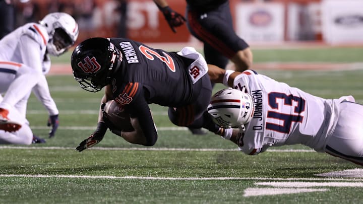 Sep 28, 2024; Salt Lake City, Utah, USA; Utah Utes running back Micah Bernard (2) is tackled by Arizona Wildcats defensive back Dalton Johnson (43) during the second quarter at Rice-Eccles Stadium. Sep 28, 2024; Salt Lake City, Utah, USA; Utah Utes running back Micah Bernard (2) is tackled by Arizona Wildcats defensive back Dalton Johnson (43) during the second quarter at Rice-Eccles Stadium.