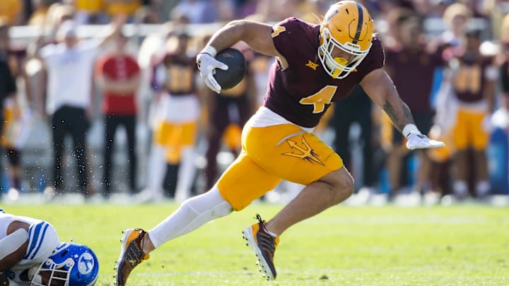 Arizona State Sun Devils running back Cam Skattebo (4) runs for a touchdown against the Brigham Young Cougars in the first half at Mountain America Stadium.