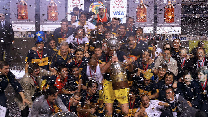 Boca Juniors footballers celebrate their...