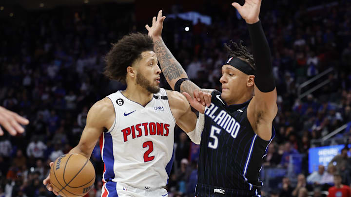 Oct 19, 2022; Detroit, Michigan, USA;  Detroit Pistons guard Cade Cunningham (2) is defended by Orlando Magic forward Paolo Banchero (5) in the second half at Little Caesars Arena. Mandatory Credit: Rick Osentoski-Imagn Images