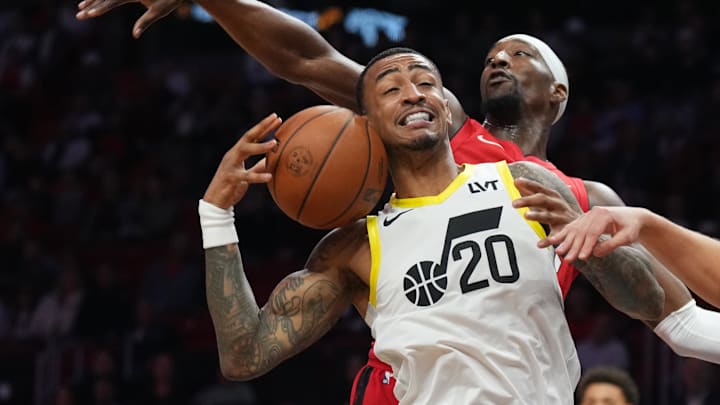 Jan 4, 2025; Miami, Florida, USA;  Utah Jazz forward John Collins (20) has his shot altered by Miami Heat center Bam Adebayo (13) during the first half at Kaseya Center. Mandatory Credit: Jim Rassol-Imagn Images
