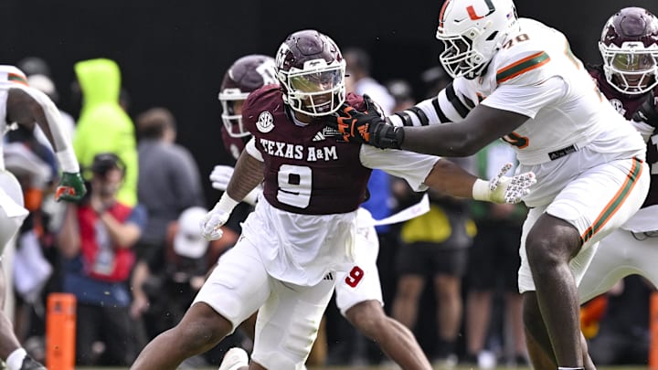 Texas A&M Aggies defensive end Cashius Howell rushes the line past Miami Hurricanes offensive lineman Markel Bell during the game between the Aggies and the Hurricanes at Kyle Field.