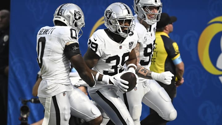 Oct 20, 2024; Inglewood, California, USA; Las Vegas Raiders cornerback Nate Hobbs (39) celebrates intercepting a Los Angeles Rams quarterback Matthew Stafford (not pictured) pass during the third quarter at SoFi Stadium. Left is Las Vegas Raiders cornerback Jakorian Bennett (0), right is defensive end Maxx Crosby (98). Mandatory Credit: Robert Hanashiro-Imagn Images