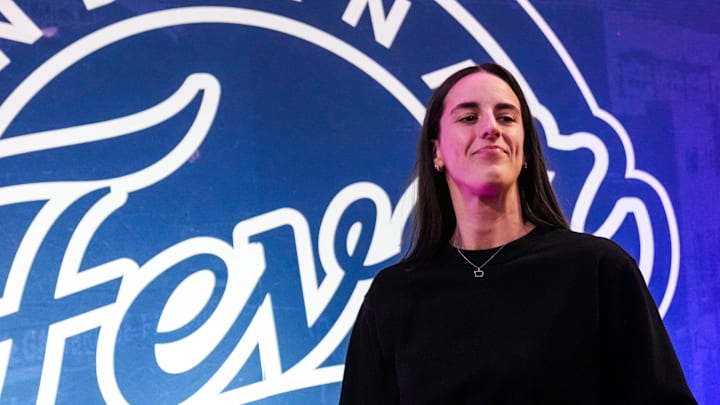 Indiana Fever guard Caitlin Clark (22) walks past the photo backdrop Wednesday, Aug. 28, 2024, during a game between the Indiana Fever and the Connecticut Sun at Gainbridge Fieldhouse in Indianapolis.