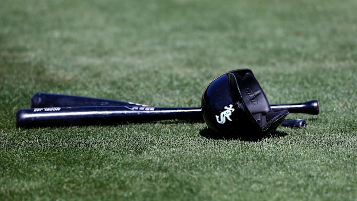 Detailed view of Chicago White Sox baseball bats and batting helmet on the field against the Seattle Mariners at Camelback Ranch in 2015.