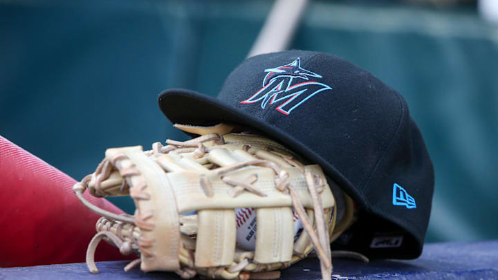 Apr 24, 2024; Atlanta, Georgia, USA; A detailed view of a Miami Marlins hat and glove in the dugout before a game against the Atlanta Braves at Truist Park. Mandatory Credit: Brett Davis-Imagn Images Apr 24, 2024; Atlanta, Georgia, USA; A detailed view of a Miami Marlins hat and glove in the dugout before a game against the Atlanta Braves at Truist Park. Mandatory Credit: Brett Davis-Imagn Images