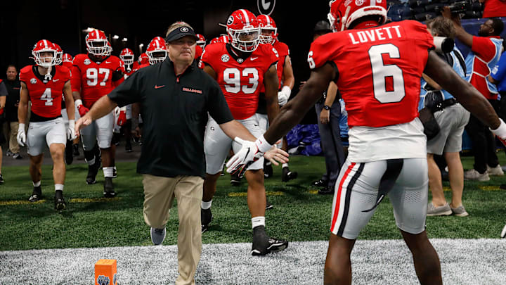 Georgia coach Kirby Smart leads his team onto the field for warm ups before the start of the NCAA Aflac Kickoff Game in Atlanta, on Saturday, Aug. 31, 2024.