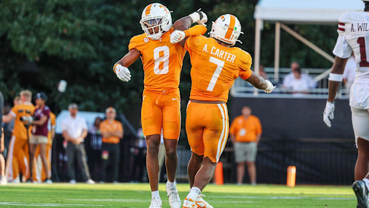 Sep 27, 2025; Starkville, Mississippi, USA; Tennessee Volunteers defensive back Colton Hood (8) and linebacker Arion Carter (7) celebrate after a defensive stop against the Mississippi State Bulldogs during the second half at Davis Wade Stadium at Scott Field. Mandatory Credit: Wesley Hale-Imagn Images