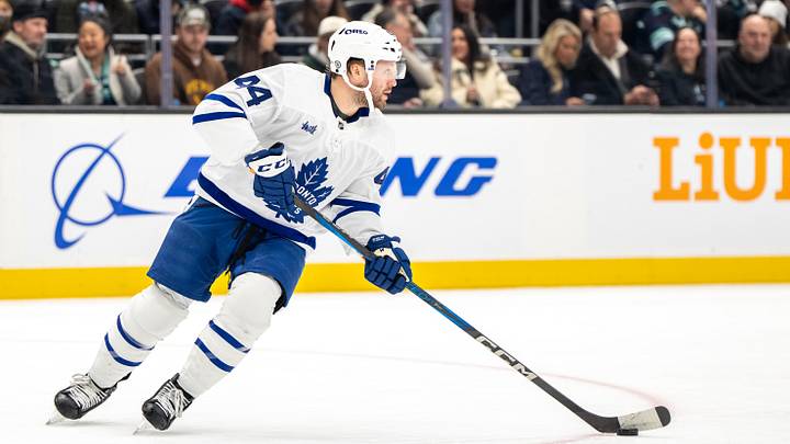 Feb 6, 2025; Seattle, Washington, USA;  Toronto Maple Leafs defenseman Morgan Rielly (44) skates with the puck against the Seattle Kraken at Climate Pledge Arena. Mandatory Credit: Stephen Brashear-Imagn Images