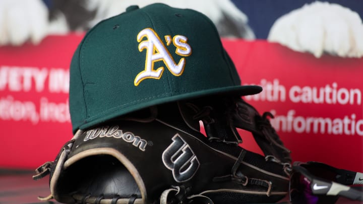 Jun 1, 2024; Atlanta, Georgia, USA; A detailed view of an Oakland Athletics hat and glove on the field against the Atlanta Braves in the sixth inning at Truist Park. Mandatory Credit: Brett Davis-USA TODAY Sports Jun 1, 2024; Atlanta, Georgia, USA; A detailed view of an Oakland Athletics hat and glove on the field against the Atlanta Braves in the sixth inning at Truist Park. Mandatory Credit: Brett Davis-USA TODAY Sports