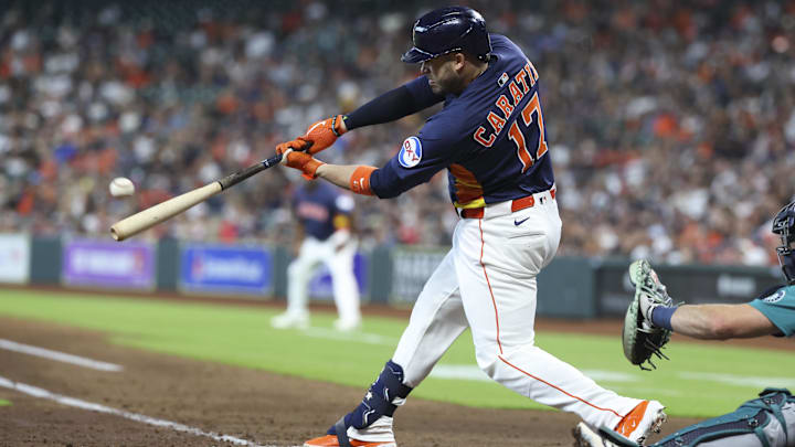 May 25, 2025; Houston, Texas, USA; Houston Astros designated hitter Victor Caratini (17) drives in a run with a sacrifice fly during the third inning against the Seattle Mariners at Daikin Park.