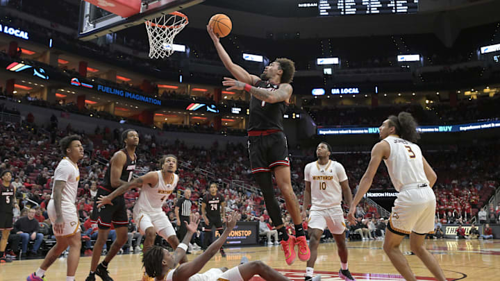 Nov 22, 2024; Louisville, Kentucky, USA;  Louisville Cardinals guard J'Vonne Hadley (1) shoots over Winthrop Eagles forward K.J. Doucet (12) during the second half at KFC Yum! Center. Louisville defeated Winthrop 76-61.