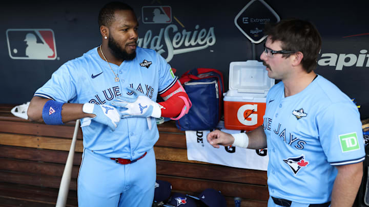 Oct 29, 2025; Los Angeles, California, USA; Toronto Blue Jays first baseman Vladimir Guerrero Jr. (27) and Toronto Blue Jays left fielder Davis Schneider (36) speak in the dugout after hitting back-to-back solo home runs during the first inning against the Los Angeles Dodgers during game five of the 2025 MLB World Series at Dodger Stadium. Mandatory Credit: Kiyoshi Mio-Imagn Images