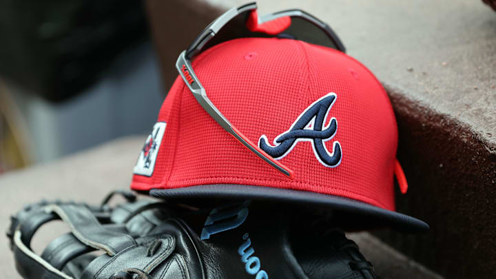 wMar 1, 2025; North Port, Florida, USA; A detail view of Atlanta Braves hat, sunglasses and glove in the dugout during the fifth inning at CoolToday Park. Mandatory Credit: Kim Klement Neitzel-Imagn Images