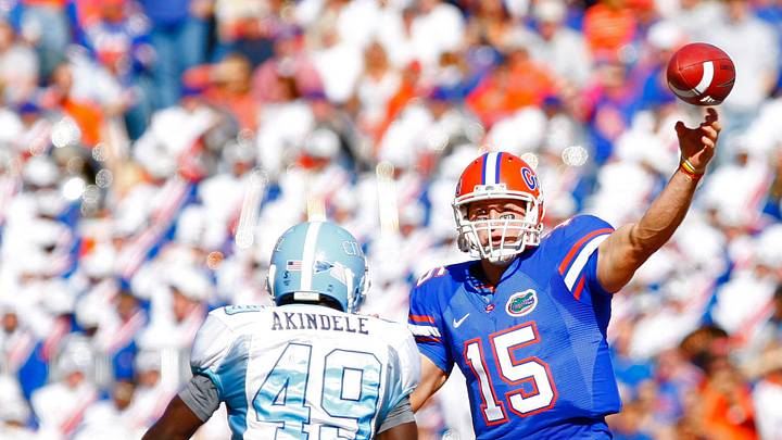 November 22, 2008; Gainesville FL, USA; Florida Gators quarterback Tim Tebow (15) throws the ball as he gets pressured by Citadel linebacker Tolu Akindele (49) during the first half at Ben Hill Griffin Stadium. Mandatory Credit: Kim Klement-USA TODAY Sports