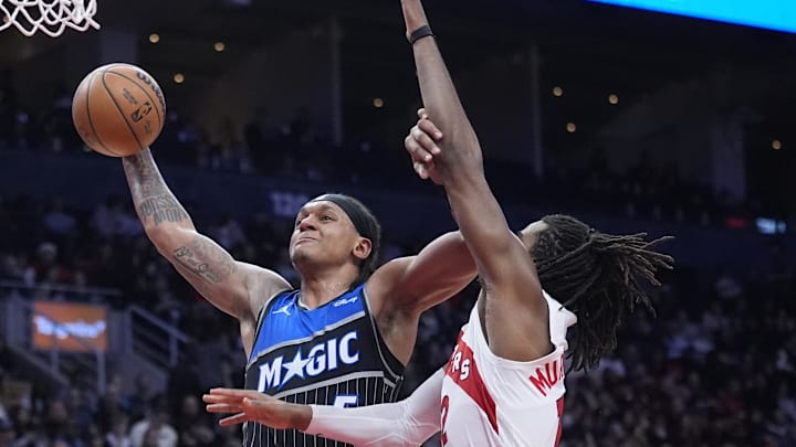 Dec 29, 2025; Toronto, Ontario, CAN; Orlando Magic forward Paolo Banchero (5) goes up to make a basket against Toronto Raptors forward Collin Murray-Boyles (12)  during the second half at Scotiabank Arena. Mandatory Credit: John E. Sokolowski-Imagn Images
