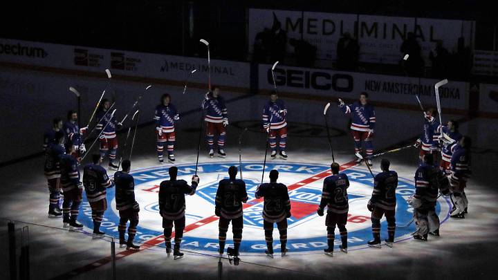 Jan 14, 2021; New York, NY, USA; New York Rangers players huddle around the center ice logo as they prepare for the home opener against the New York Islanders at Madison Square Garden. Jan 14, 2021; New York, NY, USA; New York Rangers players huddle around the center ice logo as they prepare for the home opener against the New York Islanders at Madison Square Garden.