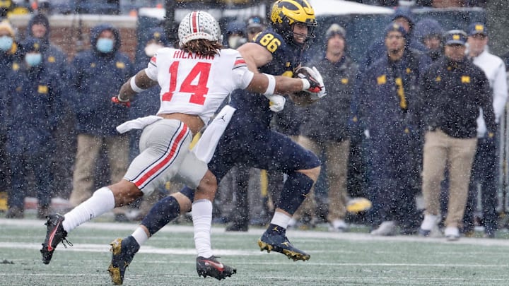 Nov 27, 2021; Ann Arbor, Michigan, USA;  Michigan Wolverines tight end Luke Schoonmaker (86) runs the ball chased by Ohio State Buckeyes safety Ronnie Hickman (14).
