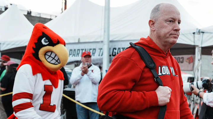 Louisville football coach Jeff Brohm leads the team as the Cards head to the locker room at the Cards March before the Louisville football game against Clemson at L&N Stadium Friday. Nov. 14, 2025