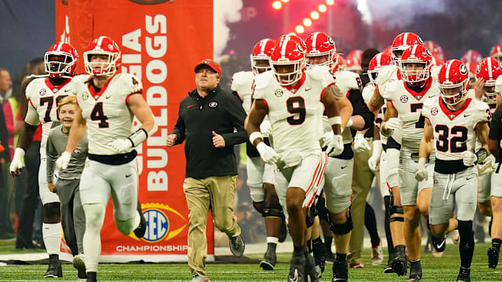 Dec 2, 2023; Atlanta, GA, USA;  Georgia Bulldogs head coach Kirby Smart runs out of the tunnel with his team before the SEC Championship game against the Alabama Crimson Tide at Mercedes-Benz Stadium. Mandatory Credit: John David Mercer-Imagn Images