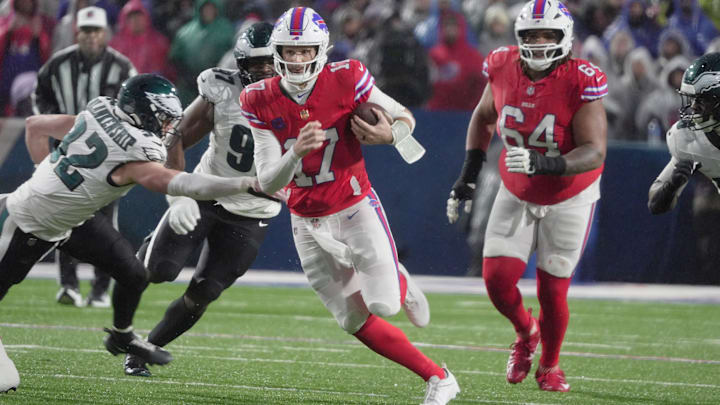Buffalo Bills quarterback Josh Allen runs with the ball for several yards before being tripped up by Philadelphia Eagles linebacker Jalyx Hunt during first half action against the Philadelphia Eagles at Highmark Stadium in Orchard Park on Dec. 28, 2025.