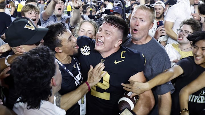 Oct 5, 2024; Nashville, Tennessee, USA;  Vanderbilt Commodores quarterback Diego Pavia celebrates with fans after defeating the Alabama Crimson Tide at FirstBank Stadium. Mandatory Credit: Butch Dill-Imagn Images