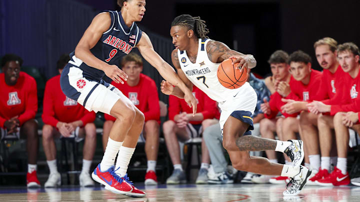 Nov 29, 2024; Paradise Island, Bahamas, BHS; West Virginia Mountaineers guard Javon Small (7) dribbles as Arizona Wildcats forward Carter Bryant (9) defends during the first half at Imperial Arena at the Atlantis resort. Nov 29, 2024; Paradise Island, Bahamas, BHS; West Virginia Mountaineers guard Javon Small (7) dribbles as Arizona Wildcats forward Carter Bryant (9) defends during the first half at Imperial Arena at the Atlantis resort.