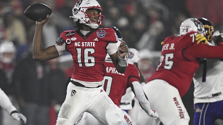 Dec 28, 2024; Annapolis, MD, USA;  North Carolina State Wolfpack quarterback CJ Bailey (16) throws from the pocket during the first half of the the Go Bowling Military Bowl against the East Carolina Pirates at Navy-Marine Corps Memorial Stadium. Mandatory Credit: Tommy Gilligan-Imagn Images