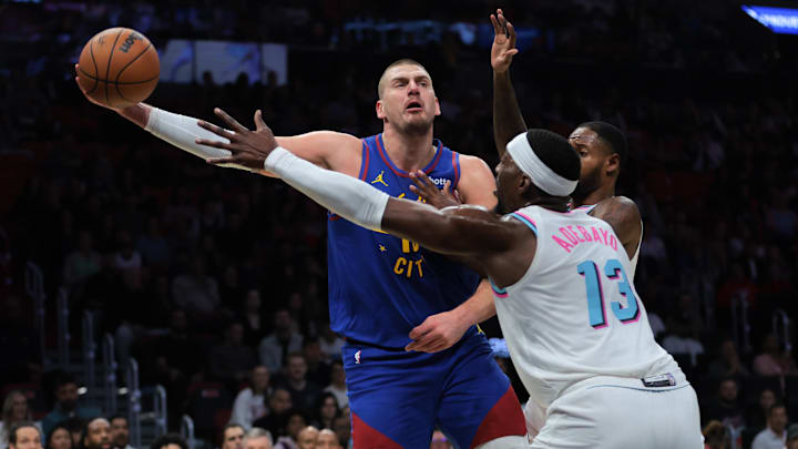 Jan 17, 2025; Miami, Florida, USA; Denver Nuggets center Nikola Jokic (15) passes the basketball as Miami Heat center Bam Adebayo (13) defends during the first quarter at Kaseya Center. Mandatory Credit: Sam Navarro-Imagn Images