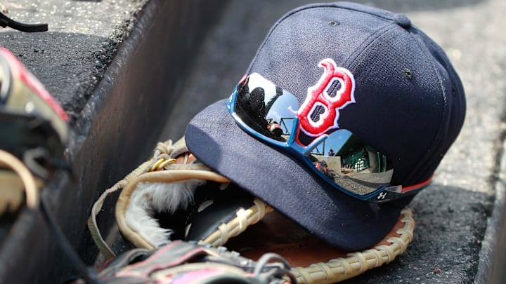 Mar 7, 2015; Sarasota, FL, USA; A general view of  Boston Red Sox hat and glove laying in the dugout at a spring training baseball game at Ed Smith Stadium. Mandatory Credit: Kim Klement-Imagn Images