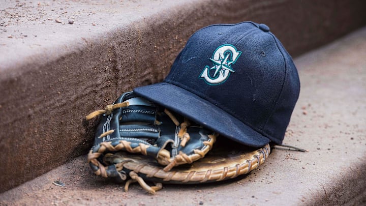 Aug 18, 2015; Arlington, TX, USA; A view of a Seattle Mariners ball cap and glove during the game between the Texas Rangers and the Seattle Mariners at Globe Life Park in Arlington. The Mariners defeat the Rangers 3-2. Mandatory Credit: Jerome Miron-Imagn Images Aug 18, 2015; Arlington, TX, USA; A view of a Seattle Mariners ball cap and glove during the game between the Texas Rangers and the Seattle Mariners at Globe Life Park in Arlington. The Mariners defeat the Rangers 3-2. Mandatory Credit: Jerome Miron-Imagn Images