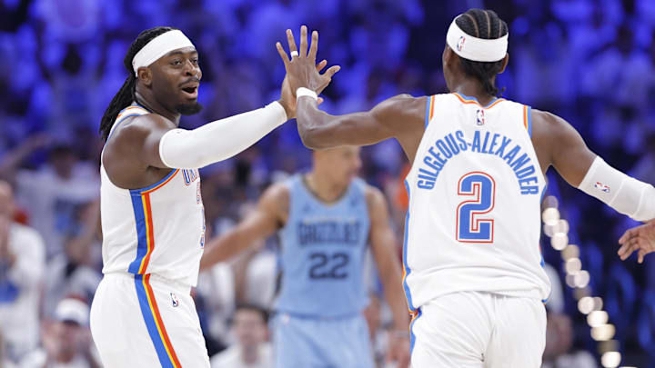 Apr 20, 2025; Oklahoma City, Oklahoma, USA; Oklahoma City Thunder guard Luguentz Dort (5) high fives guard Shai Gilgeous-Alexander (2) after scoring a three point basket against the Memphis Grizzlies during the second half at Paycom Center. Mandatory Credit: Alonzo Adams-Imagn Images
