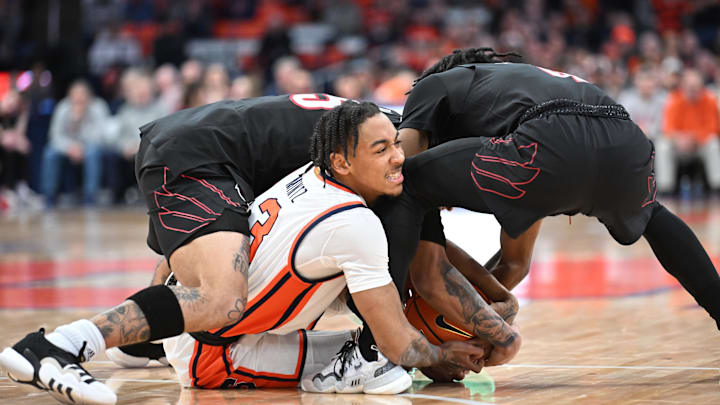 Feb 7, 2024; Syracuse, New York, USA; Syracuse Orange guard Judah Mintz (3) battles two Louisville