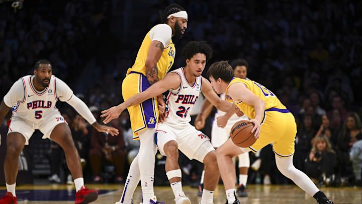 Nov 8, 2024; Los Angeles, California, USA; Los Angeles Lakers guard Austin Reaves (15) dribbles against Philadelphia 76ers guard Jared McCain (20) during the first half at Crypto.com Arena. Mandatory Credit: Jonathan Hui-Imagn Images