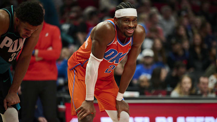 Nov 30, 2025; Portland, Oregon, USA; Oklahoma City Thunder guard Shai Gilgeous-Alexander (2) smiles at a fan during the second half in a game against the Portland Trail Blazers at Moda Center. Mandatory Credit: Troy Wayrynen-Imagn Images