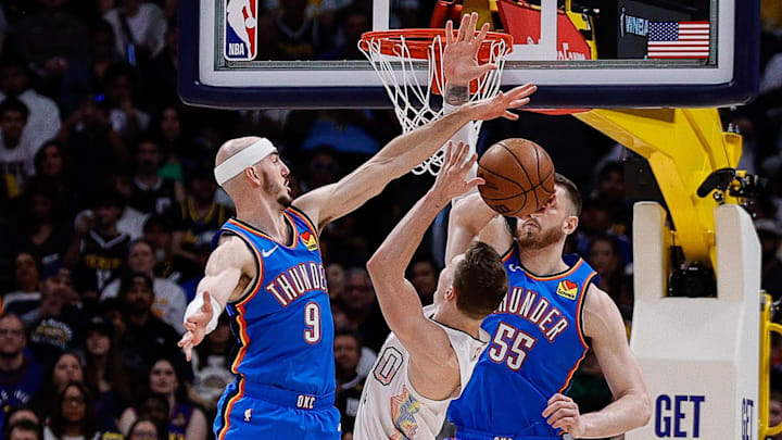 May 15, 2025; Denver, Colorado, USA; Denver Nuggets guard Christian Braun (0) attempts a shot under pressure from Oklahoma City Thunder guard Alex Caruso (9) and center Isaiah Hartenstein (55) in the second quarter during game six of the second round for the 2025 NBA Playoffs at Ball Arena. Mandatory Credit: Isaiah J. Downing-Imagn Images