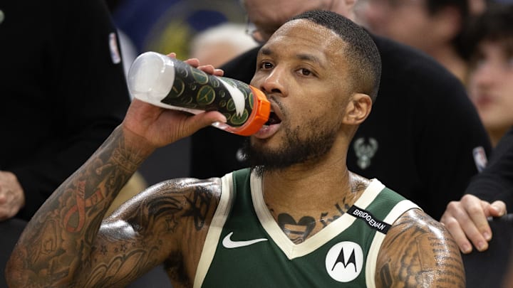 Mar 18, 2025; San Francisco, California, USA: Milwaukee Bucks guard Damian Lillard (0) hydrates while sitting on the bench during the second quarter against the Golden State Warriors at Chase Center. Mandatory Credit: D. Ross Cameron-Imagn Images