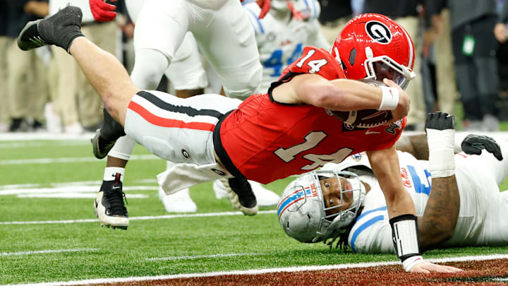 Jan 1, 2026; New Orleans, LA, USA; Georgia Bulldogs quarterback Gunner Stockton (14) scores a touchdown against the Mississippi Rebels in the second quarter during the 2026 Sugar Bowl and quarterfinal game of the College Football Playoff at Caesars Superdome. Mandatory Credit: Amber Searls-Imagn Images
