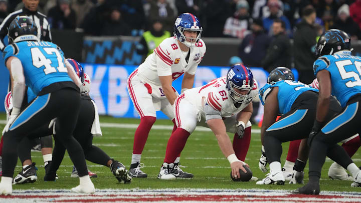 Nov 10, 2024; Munich, Germany; New York Giants quarterback Daniel Jones (8) takes the snap from center John Michael Schmitz Jr. (61) in the first half during the 2024 NFL Munich Game at Allianz Arena. Mandatory Credit: Kirby Lee-Imagn Images Nov 10, 2024; Munich, Germany; New York Giants quarterback Daniel Jones (8) takes the snap from center John Michael Schmitz Jr. (61) in the first half during the 2024 NFL Munich Game at Allianz Arena. Mandatory Credit: Kirby Lee-Imagn Images