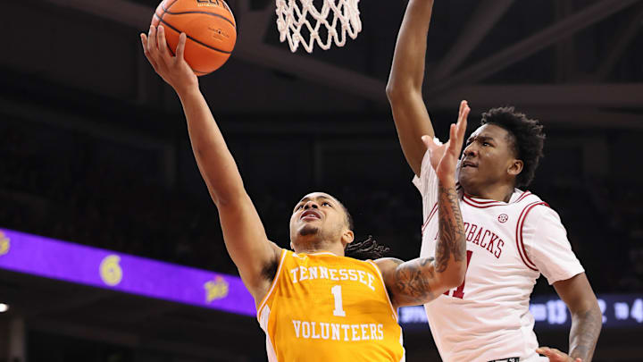 Jan 3, 2026; Fayetteville, Arkansas, USA; Tennessee Volunteers guard Amari Evans (1) shoots in the first half as Arkansas Razorbacks wing Karter Knox (11) defends at Bud Walton Arena. Mandatory Credit: Nelson Chenault-Imagn Images