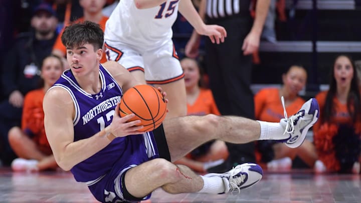 Jan 26, 2025; Champaign, Illinois, USA;  Northwestern Wildcats guard Brooks Barnhizer (13) grabs the ball off the court during the first half against the Illinois Fighting Illini at State Farm Center. Mandatory Credit: Ron Johnson-Imagn Images