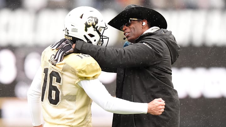 Apr 27, 2024; Boulder, CO, USA; Colorado Buffaloes head coach Deion Sanders talks to quarterback