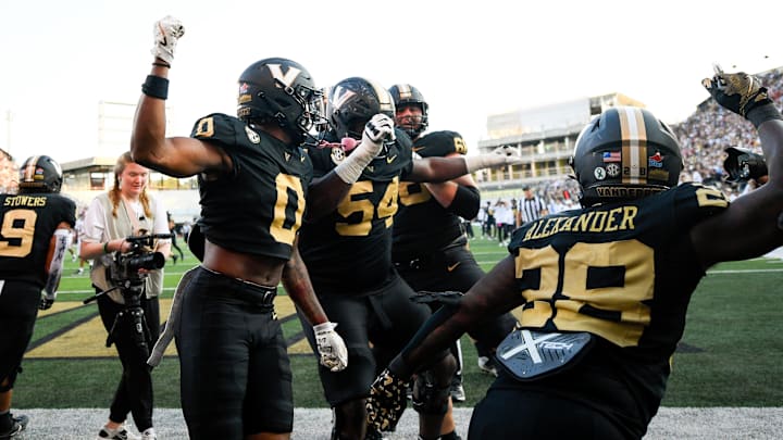 Oct 5, 2024; Nashville, Tennessee, USA;  Vanderbilt Commodores wide receiver Junior Sherrill (0) celebrates with teammates after scoring a touchdown against the Alabama Crimson Tide during the second half at FirstBank Stadium. Mandatory Credit: Steve Roberts-Imagn Images