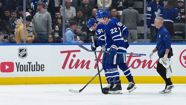 Oct 15, 2026; Toronto, Ontario, CAN;  Toronto Maple Leafs center John Tavares (91) is helped off the ice by defenseman Jake McCabe (22) against the Buffalo Sabres during the third period at Scotiabank Arena.  Mandatory Credit: Nick Turchiaro-Imagn Images