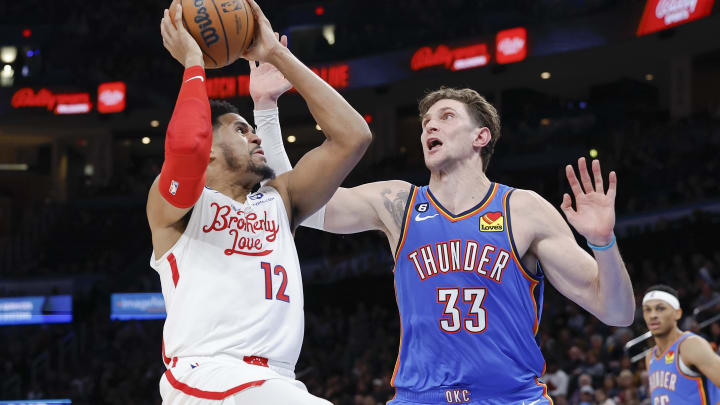 Dec 31, 2022; Oklahoma City, Oklahoma, USA; Philadelphia 76ers forward Tobias Harris (12) shoots the ball against Oklahoma City Thunder center Mike Muscala (33) during the second quarter at Paycom Center. Mandatory Credit: Alonzo Adams-USA TODAY Sports