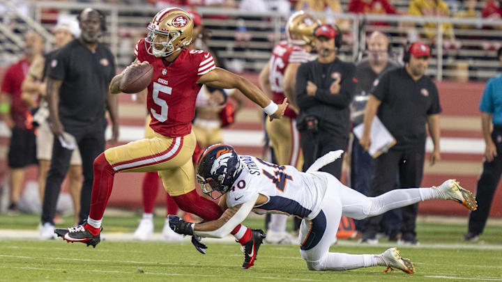 August 19, 2023; Santa Clara, California, USA; San Francisco 49ers quarterback Trey Lance (5) is tackled by Denver Broncos linebacker Justin Strnad (40) during the fourth quarter at Levi's Stadium. Mandatory Credit: Kyle Terada-Imagn Images