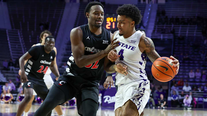 Feb 11, 2026; Manhattan, Kansas, USA; Kansas State Wildcats guard P.J. Haggerty (4) is guarded by Cincinnati Bearcats guard Jalen Celestine (32) during the second half at Bramlage Coliseum. 